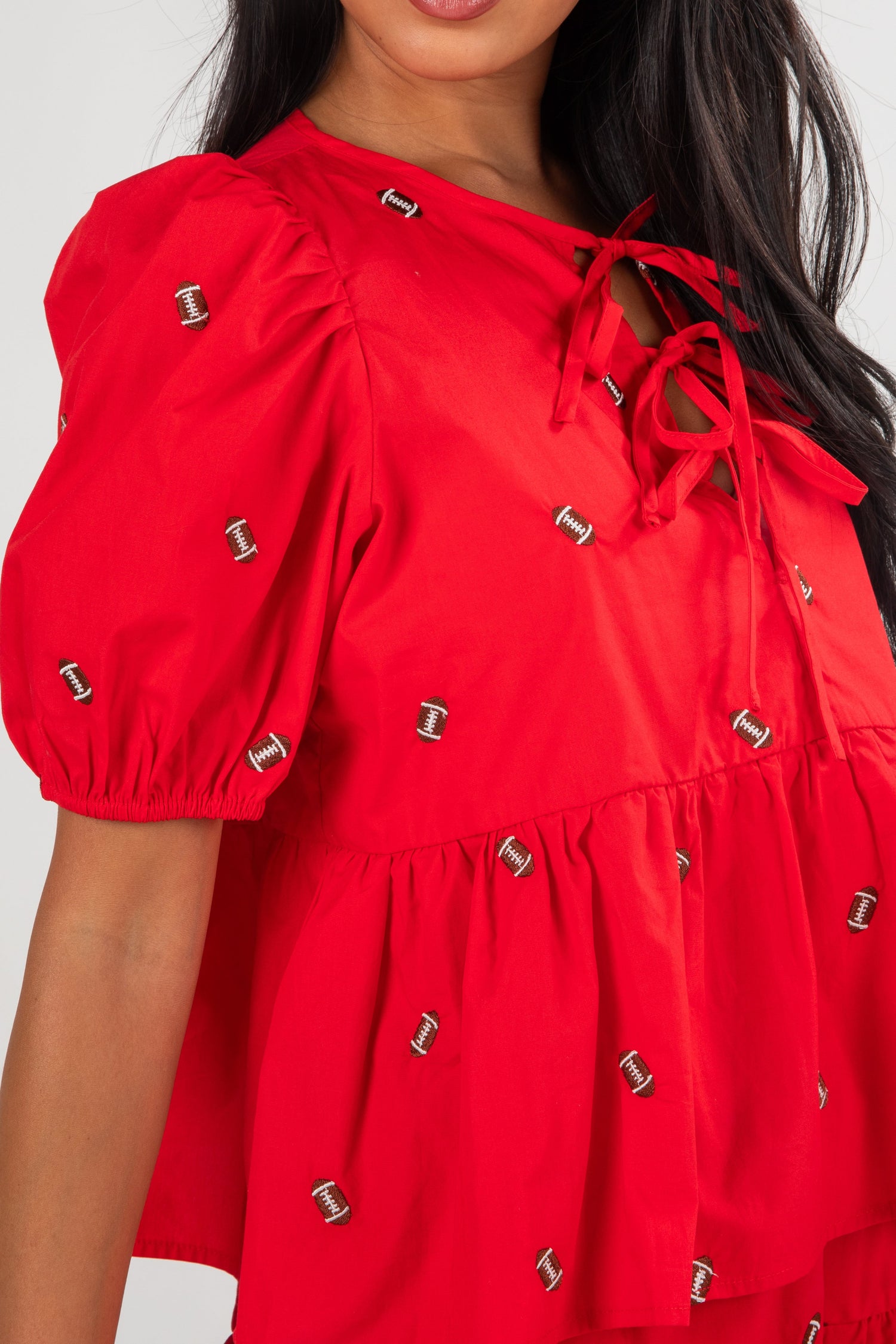 Red dress with puff sleeves and decorative elements on a white background