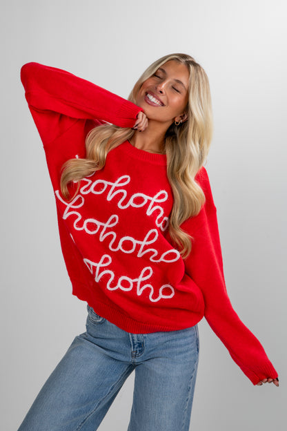 Woman wearing a red sweater with &