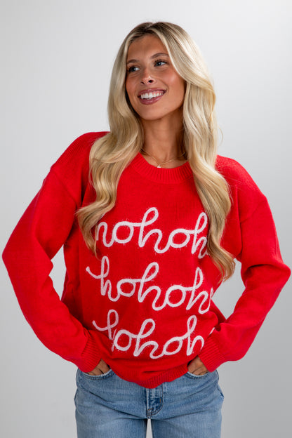 Woman wearing a red sweater with &