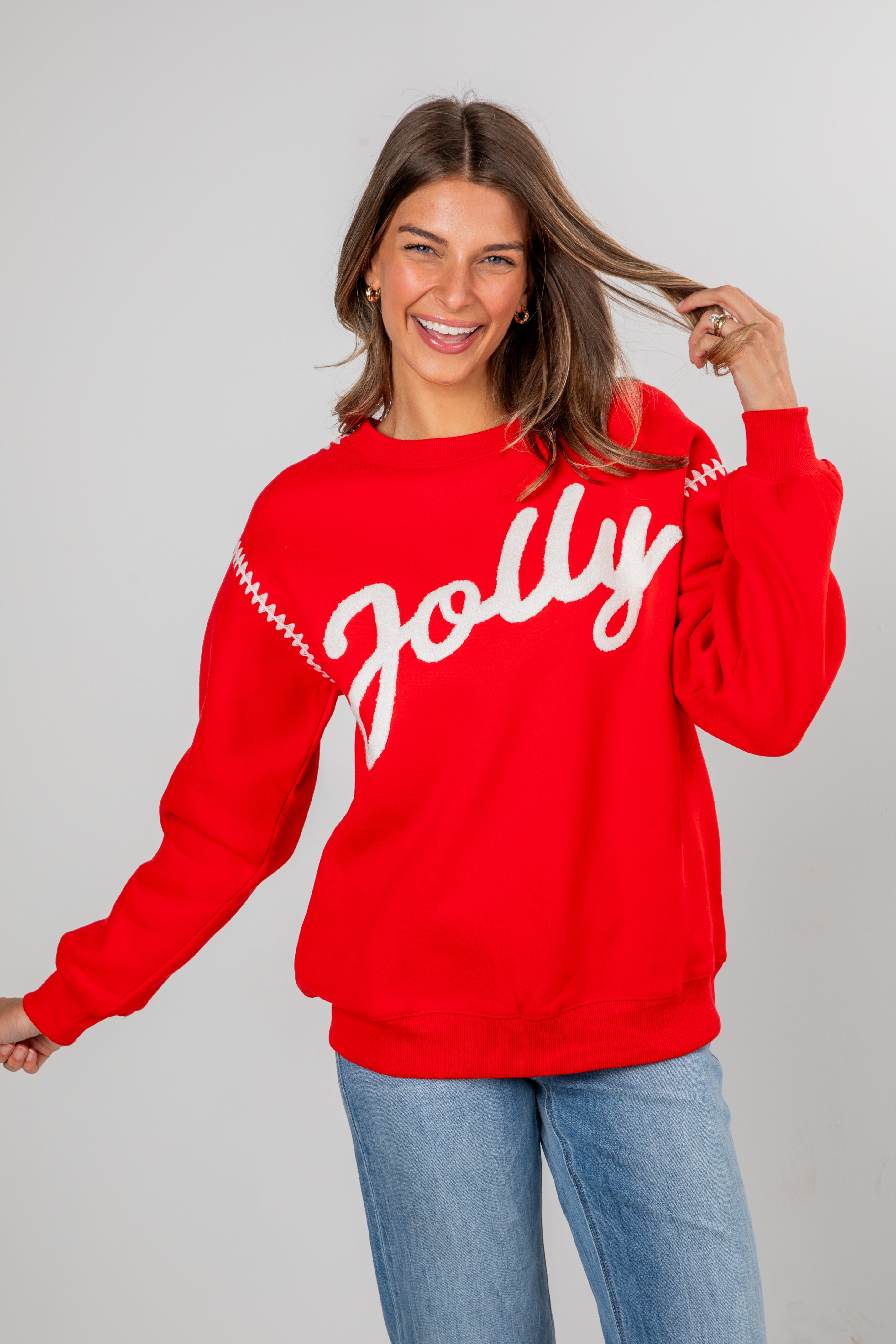 Woman wearing a red sweatshirt with &
