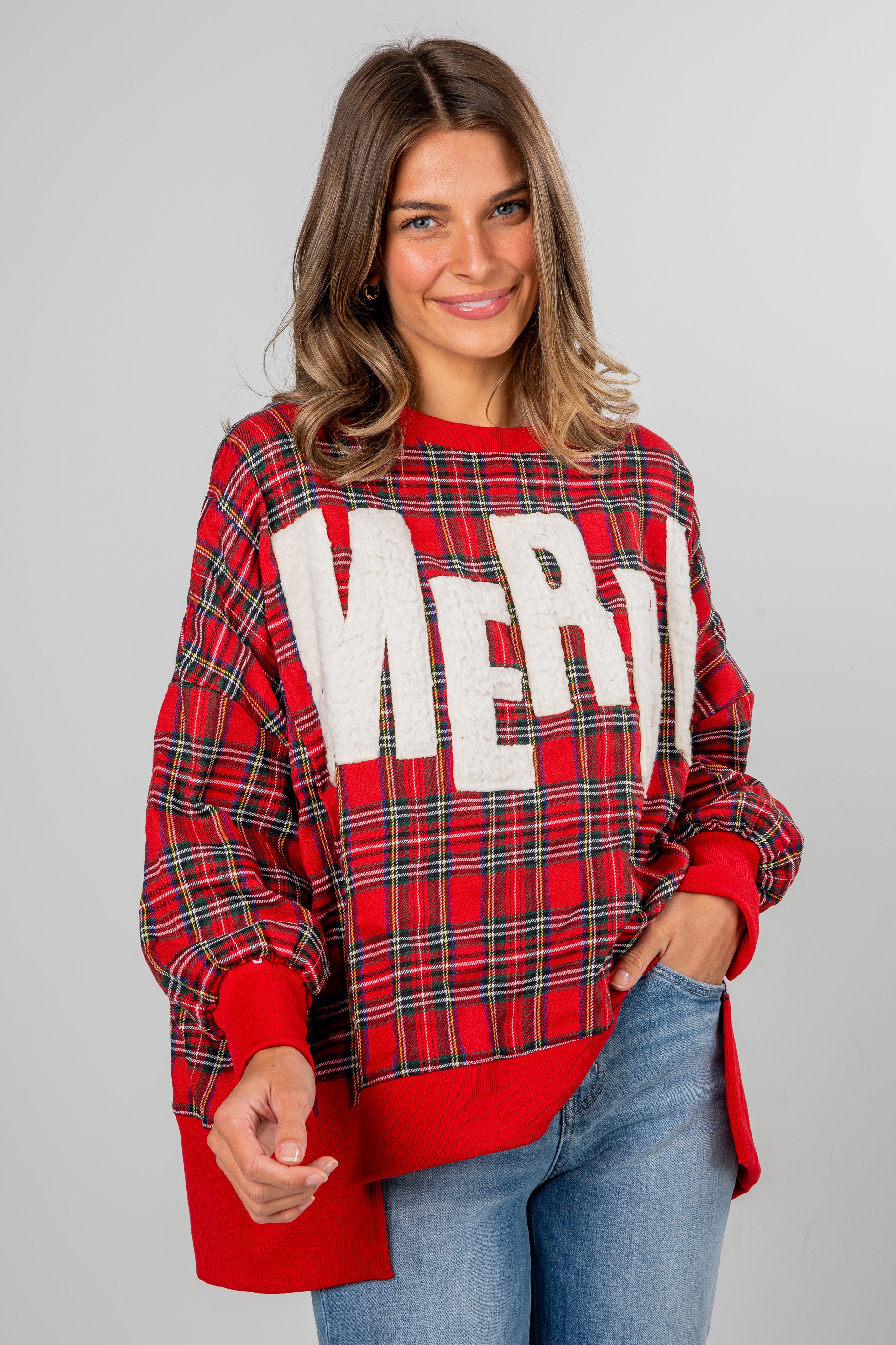Woman wearing a red plaid sweater with &