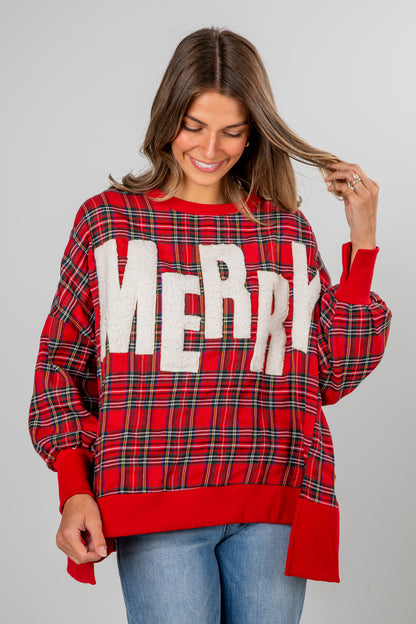 Woman wearing a red plaid sweater with &