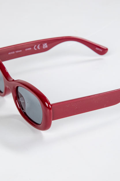 Red sunglasses on a white background