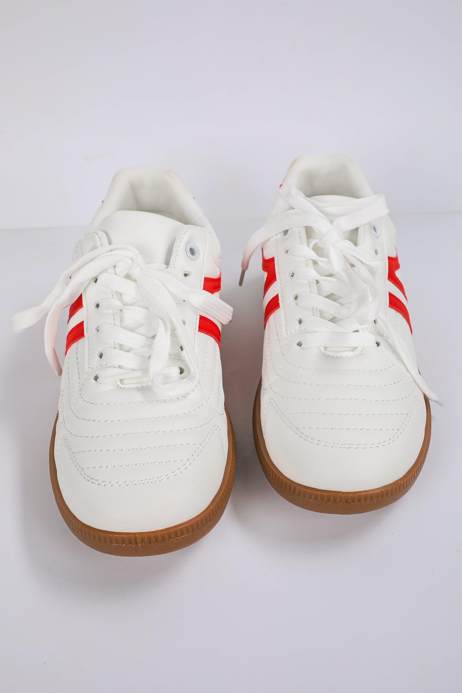 White sneakers with red stripes on a white background