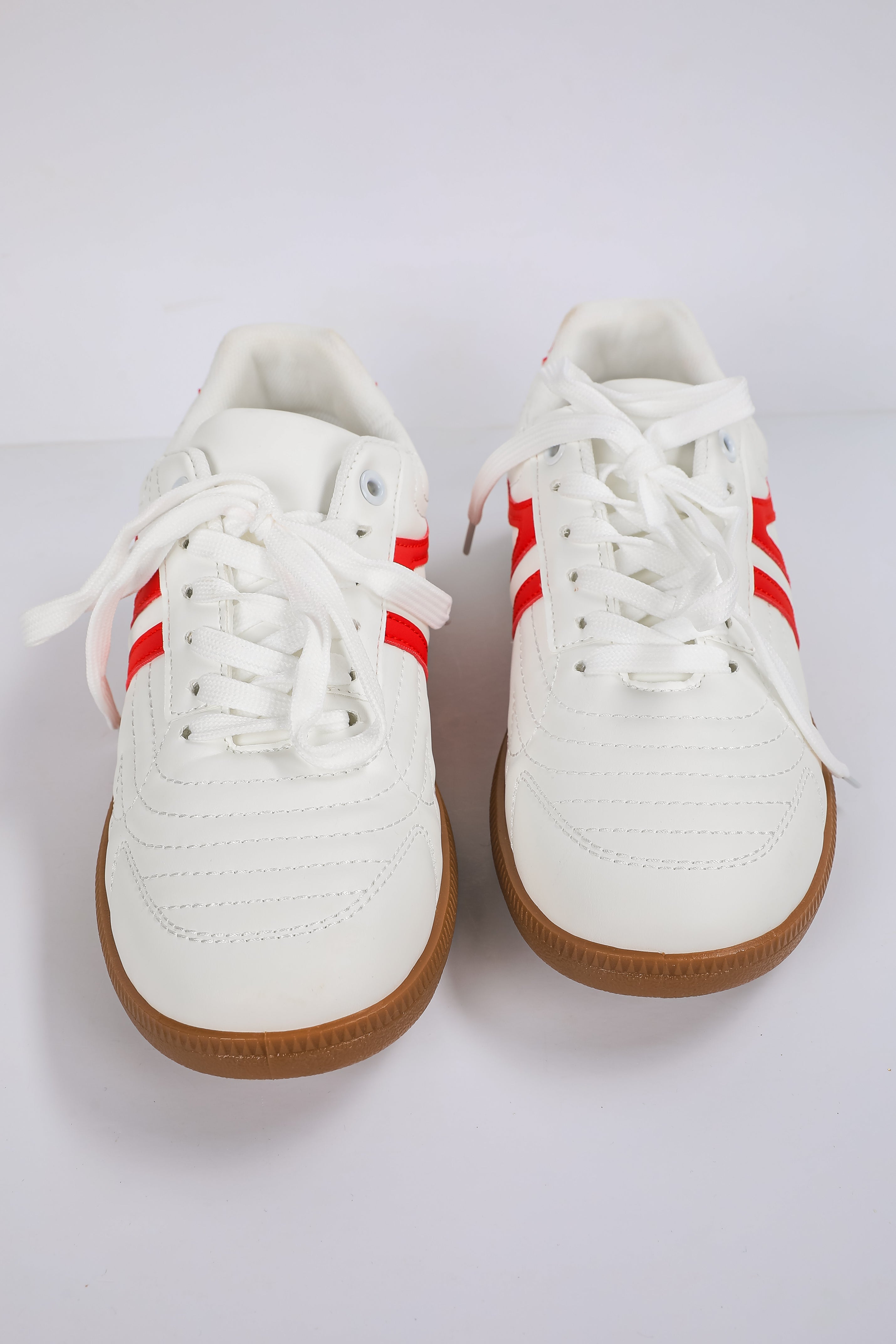 White sneakers with red stripes on a white background