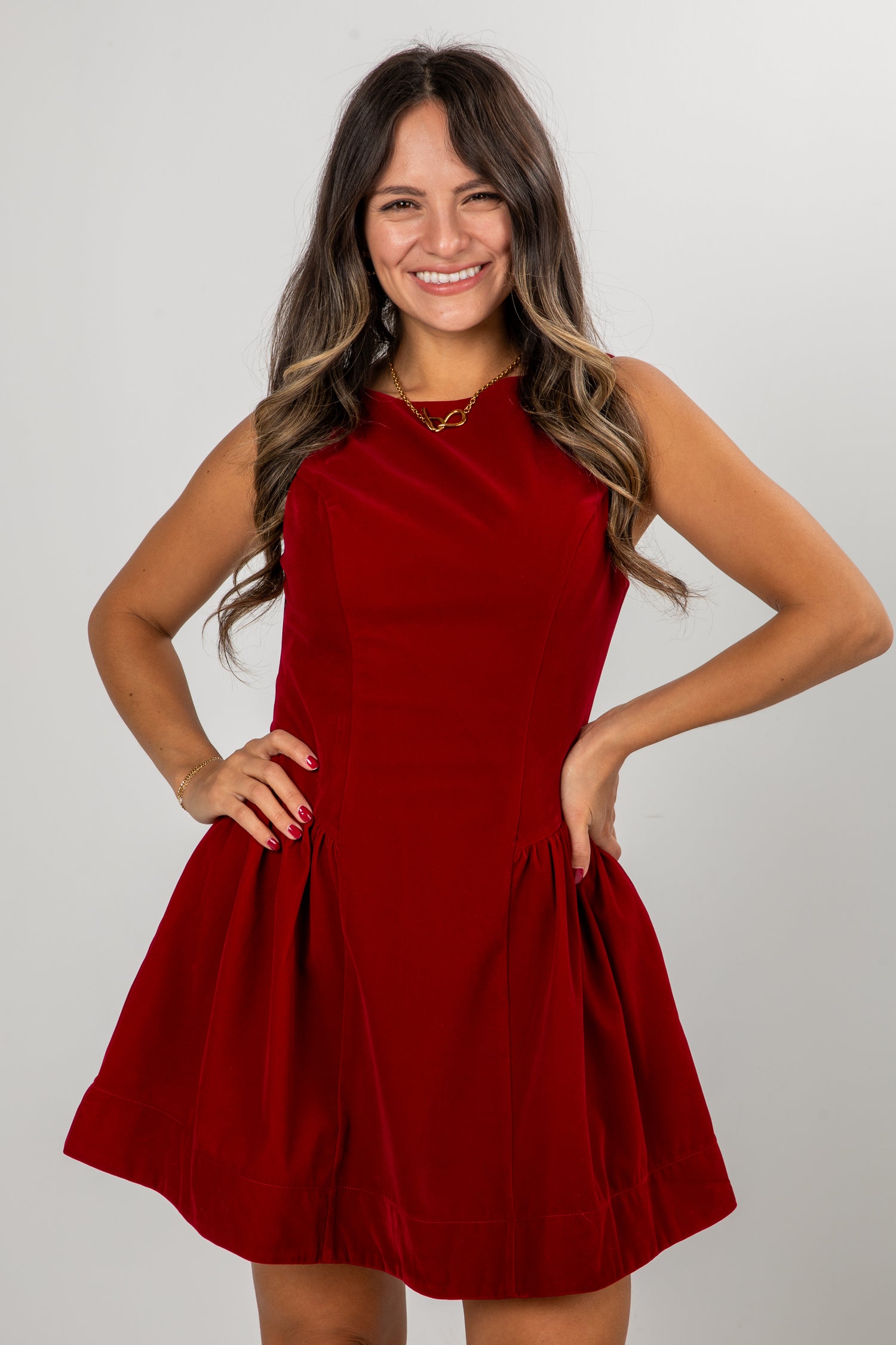 Woman wearing a red dress against a plain background