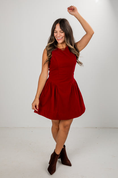 Woman wearing a red dress on a white background