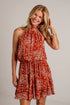 rust mini dress features an ivory paisley print, a flattering halter neckline, and a flowy silhouette