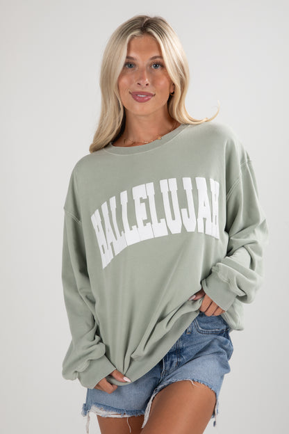 Woman wearing a green sweatshirt with &