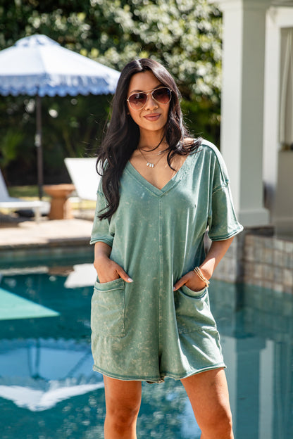 Woman wearing a green dress by a poolside