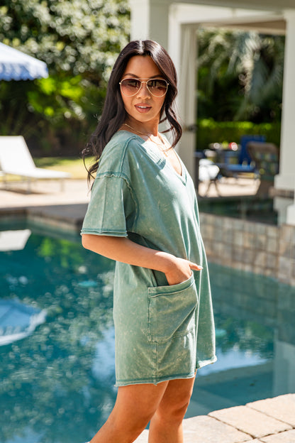 Woman wearing a green dress by a poolside