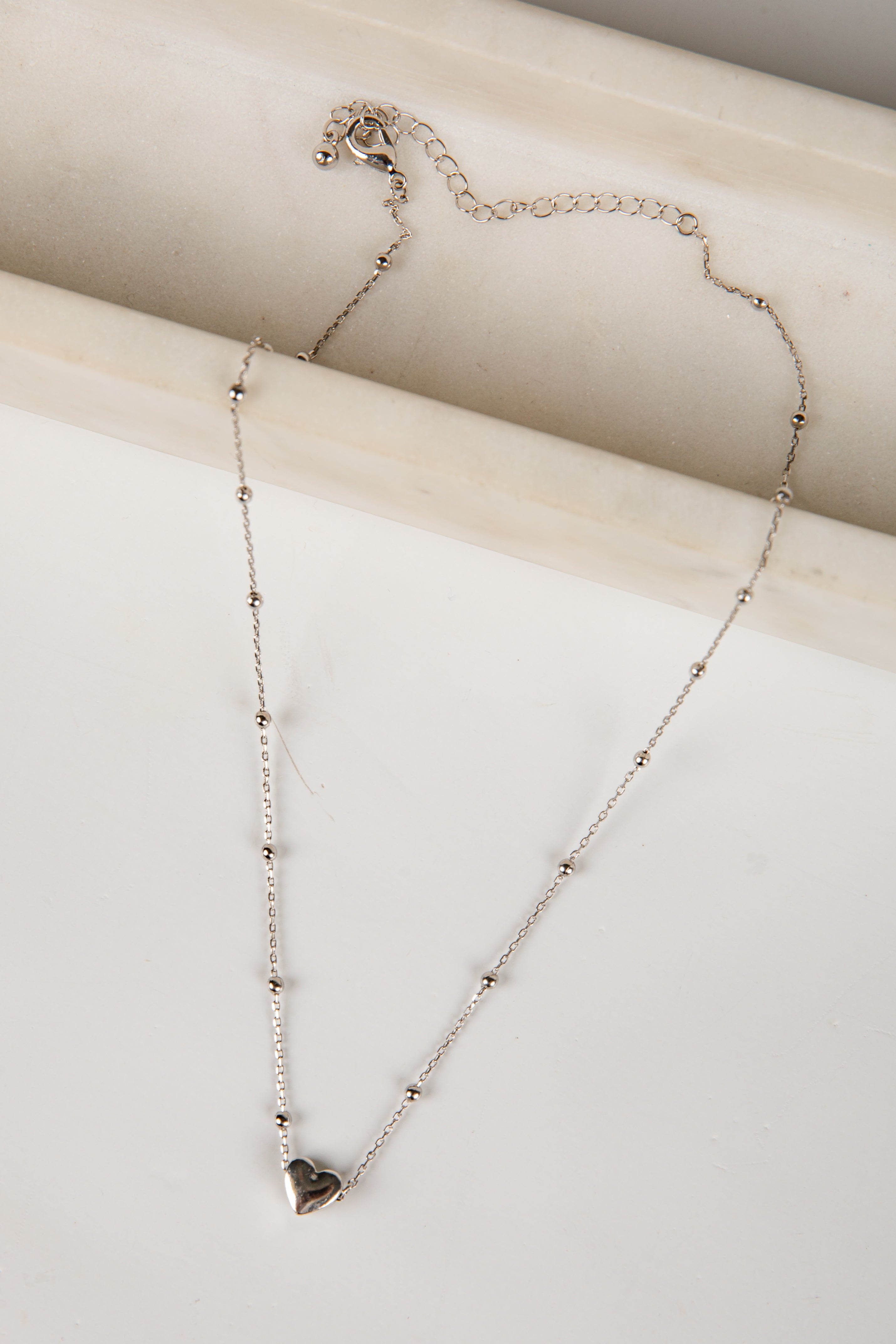 Necklace with a heart pendant on a light background