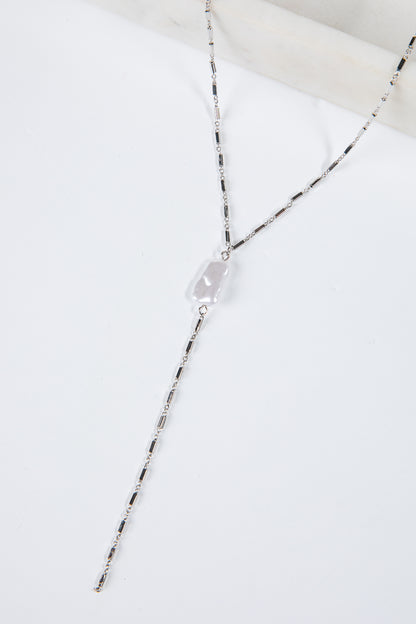 Necklace with a clear pendant on a white background