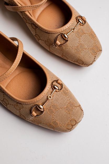 A pair of beige Gucci flats featuring the brand&