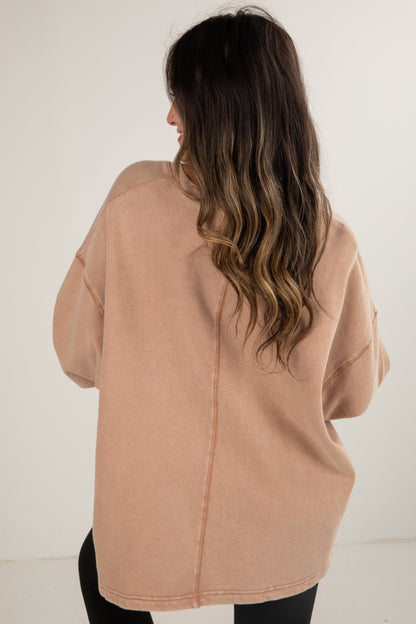 Woman wearing a beige coat against a white background