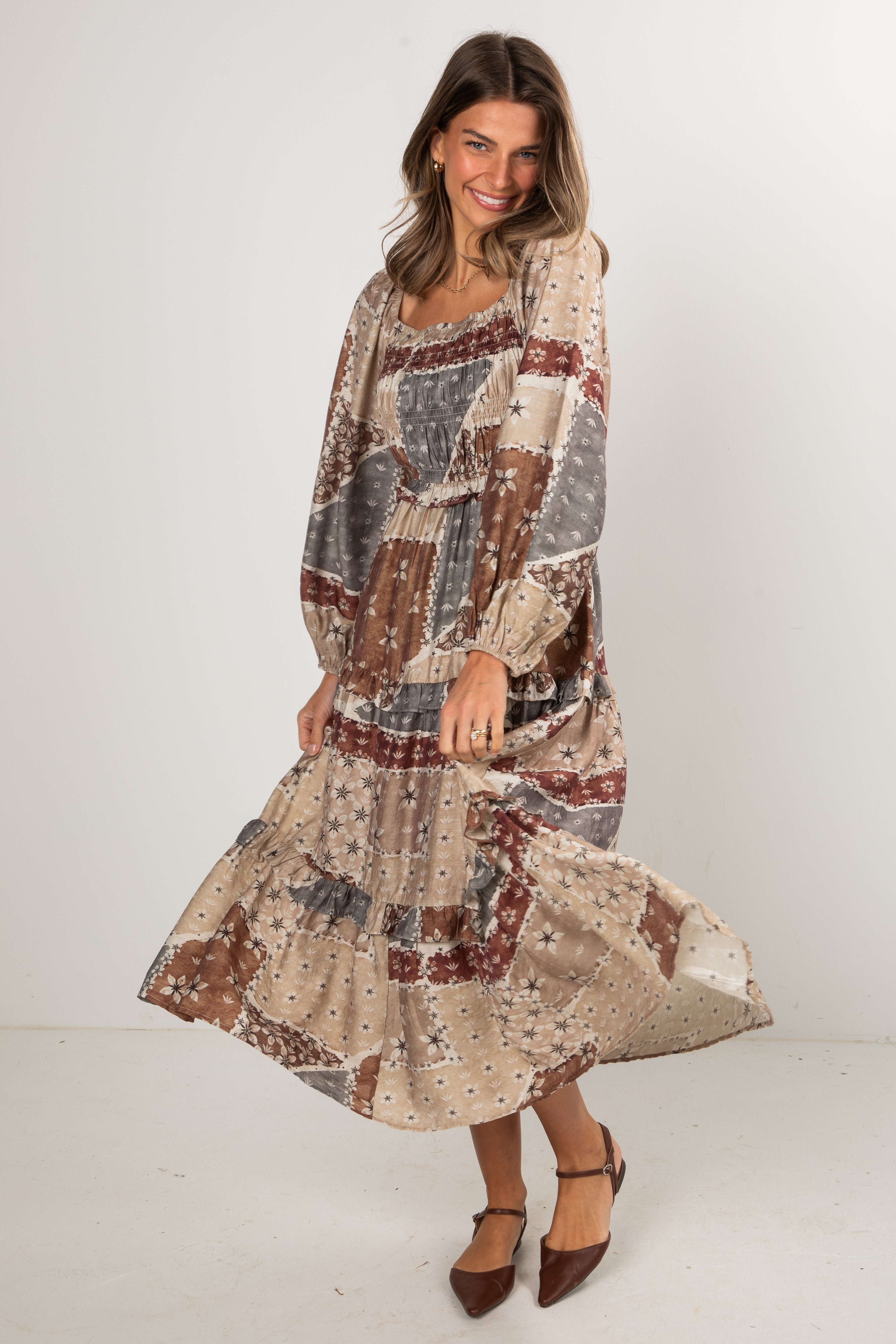 Woman wearing a patterned dress on a white background