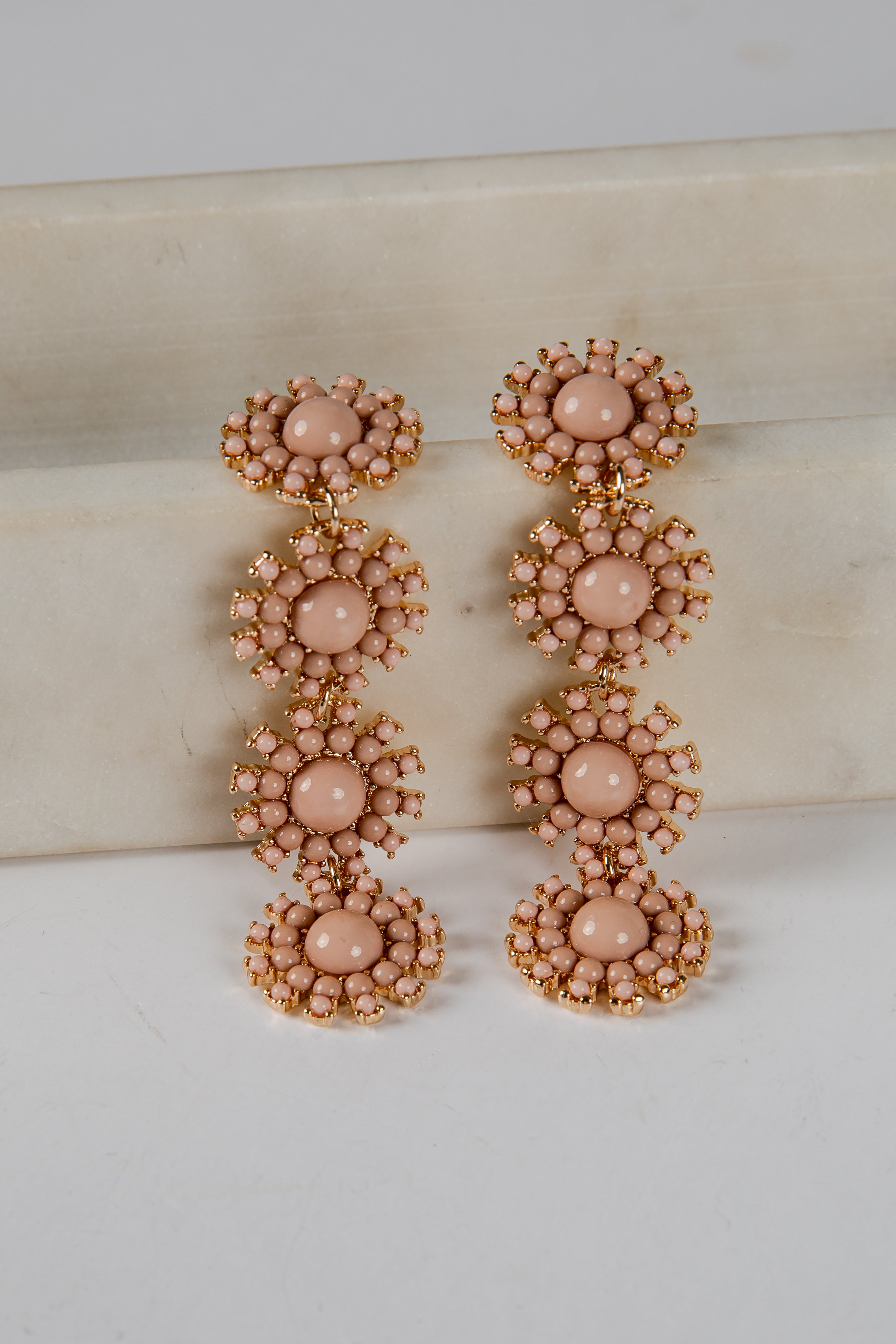 Pair of pink beaded earrings on a light background