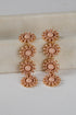 Pair of pink beaded earrings on a light background