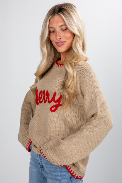 Woman wearing a beige sweater with red text on a plain background