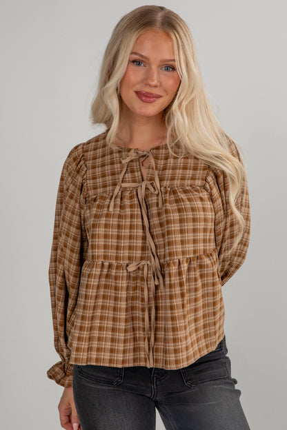 Woman wearing a plaid blouse with a gray background