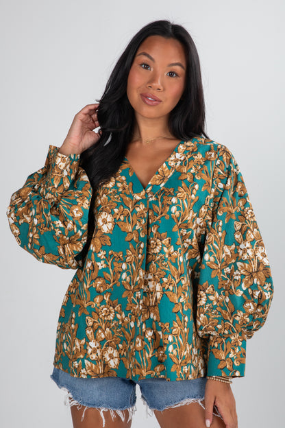 Woman wearing a floral blouse with a plain background