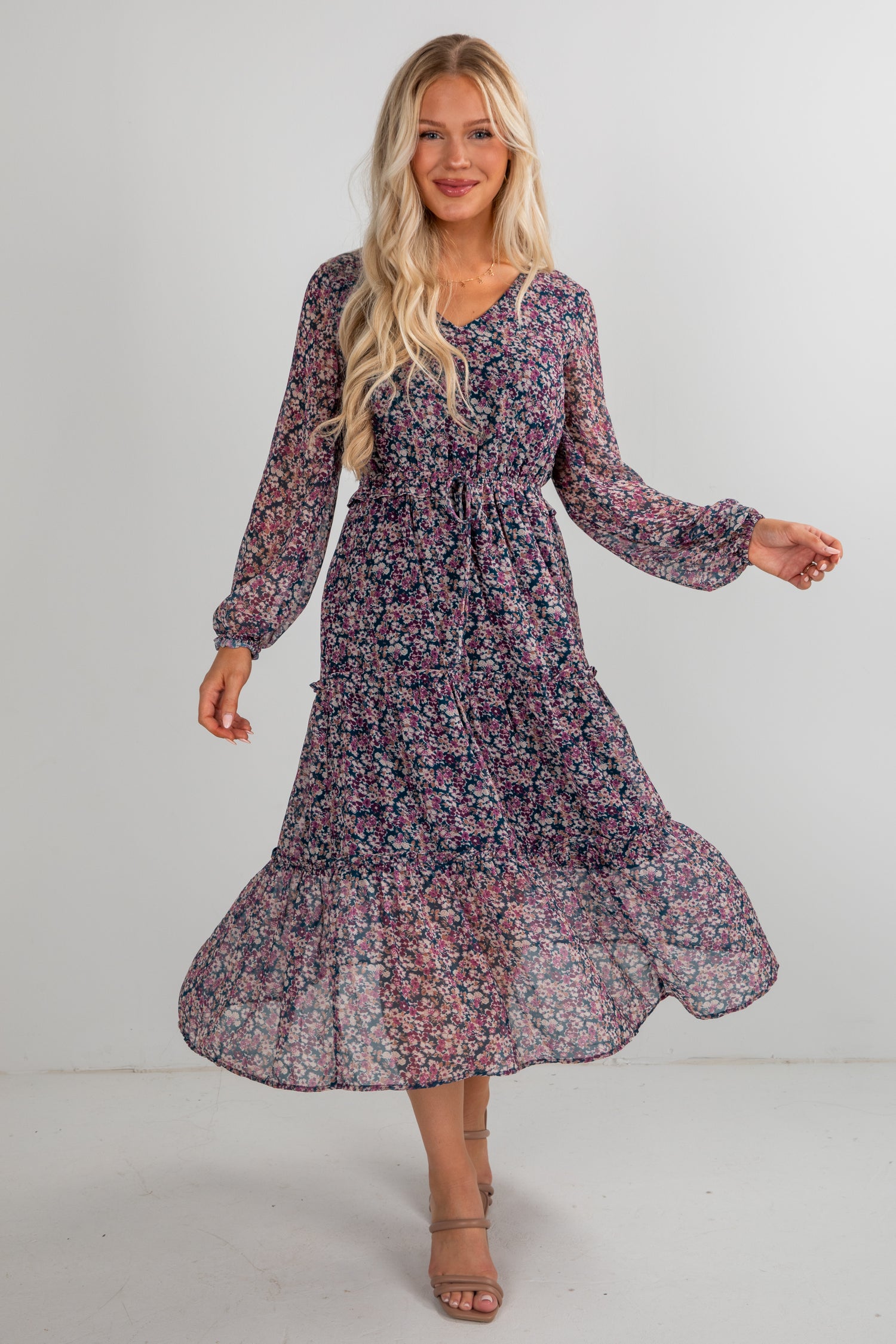 Woman wearing a floral dress on a plain background