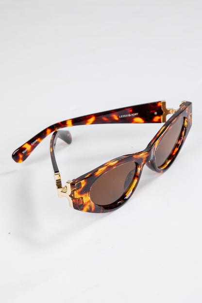 Sunglasses with tortoiseshell frame and brown lenses on a white background