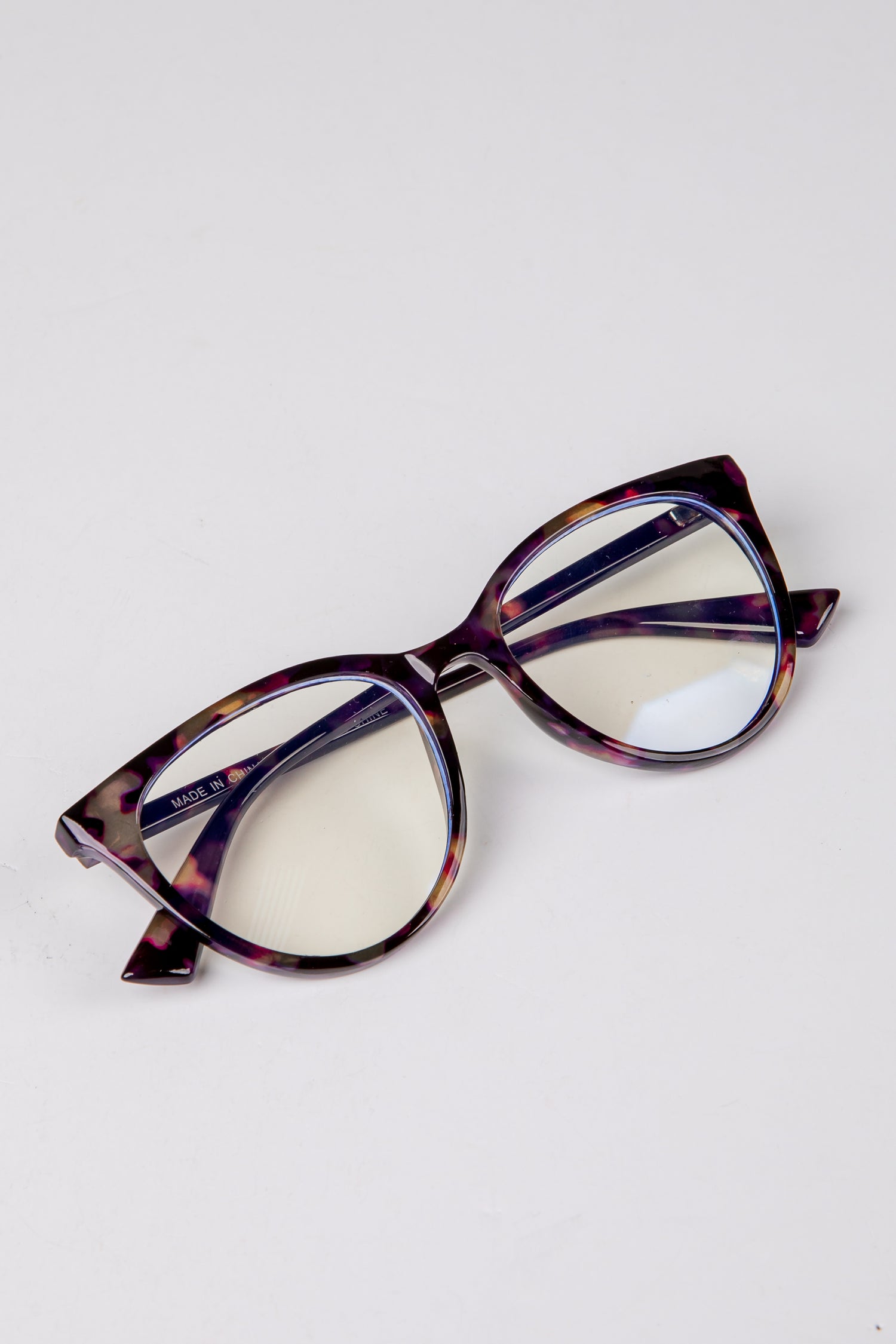 Cat-eye glasses with a tortoiseshell frame on a white background