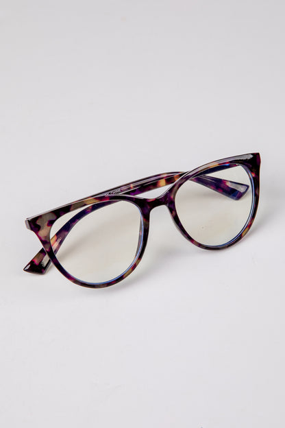 Tortoiseshell cat-eye glasses on a light gray background