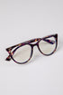 Tortoiseshell cat-eye glasses on a light gray background