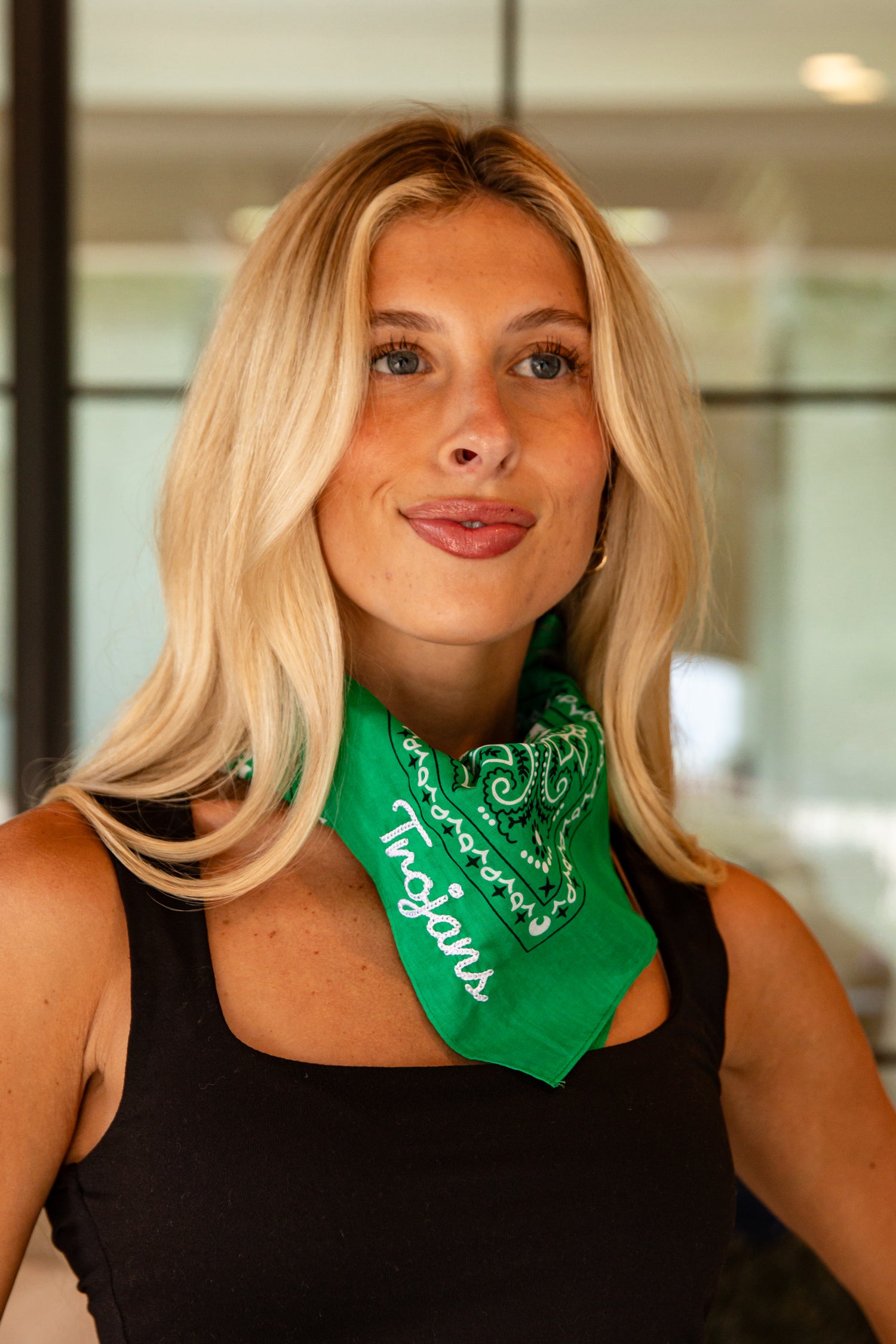 Woman wearing a green bandana with &
