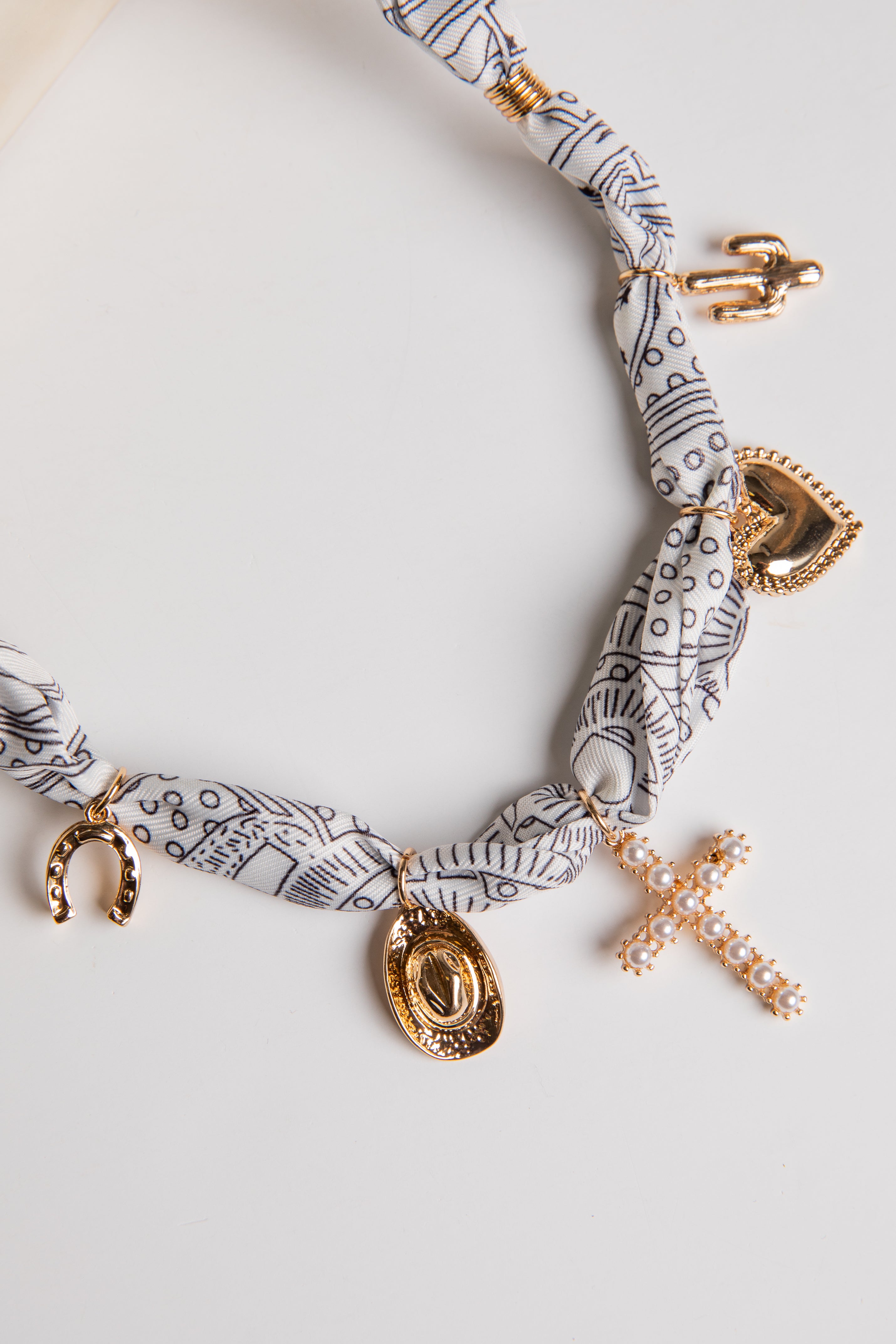 Necklace with gold charms on a white background