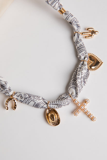 Necklace with gold charms on a white background