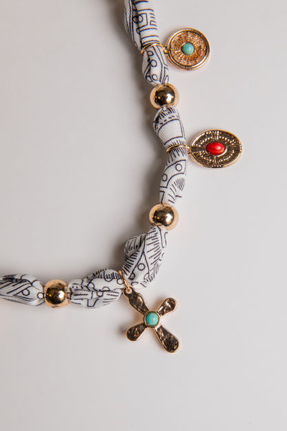Necklace with decorative beads on a light gray background