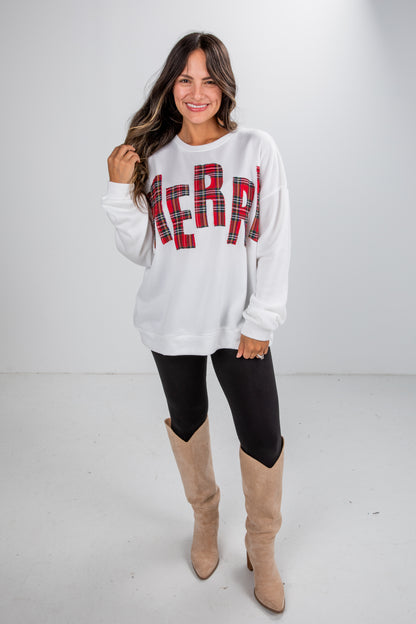 Woman wearing a white sweater with &