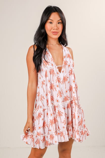 Woman wearing a floral dress with a plain background