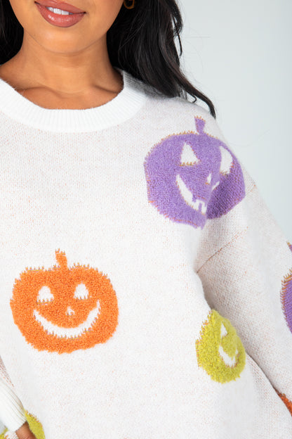 Close-up of a sweater with Halloween-themed pumpkins on a white background