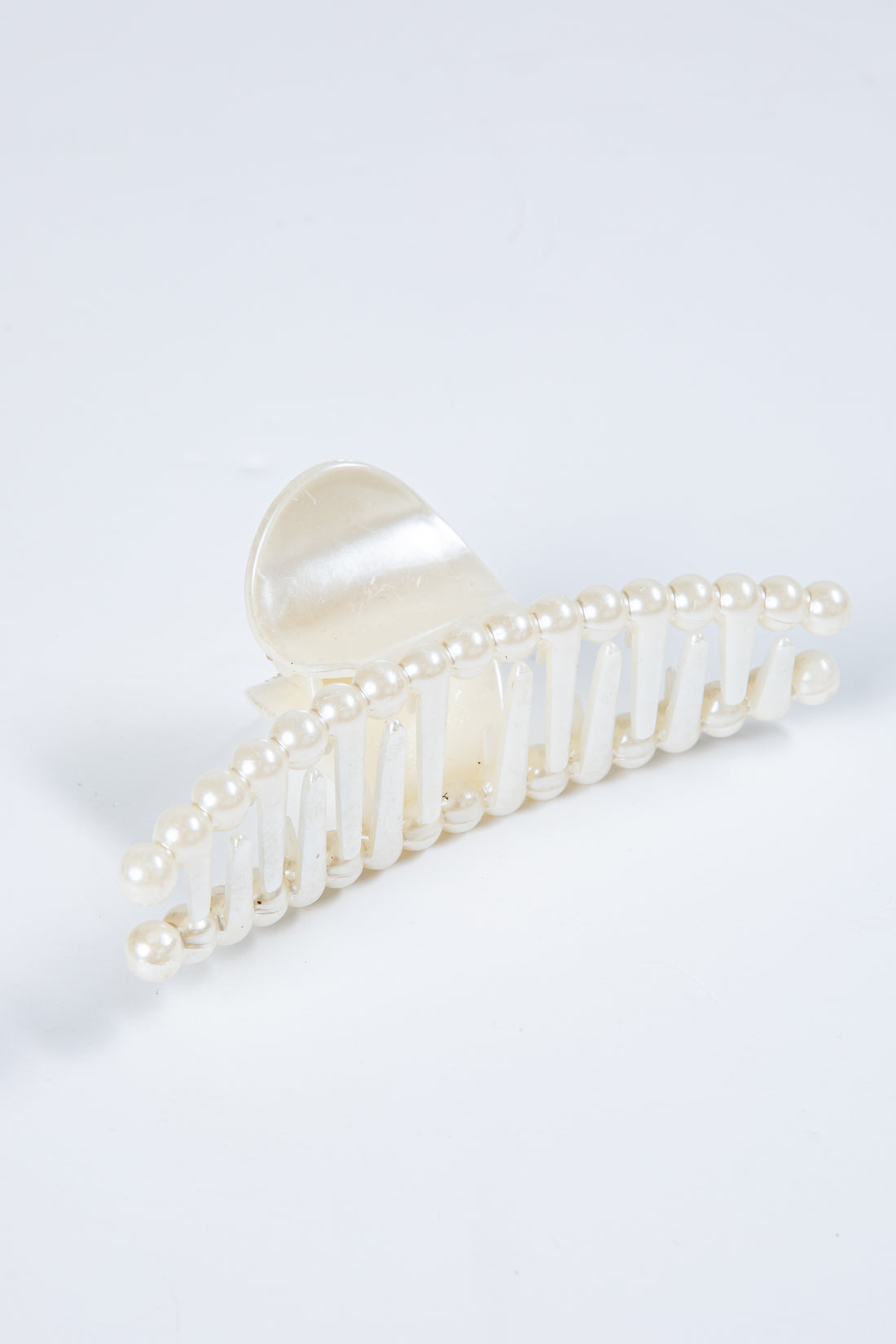 Pearl decorative hair clip on a white background