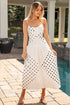Woman in a polka dot dress standing by a poolside.