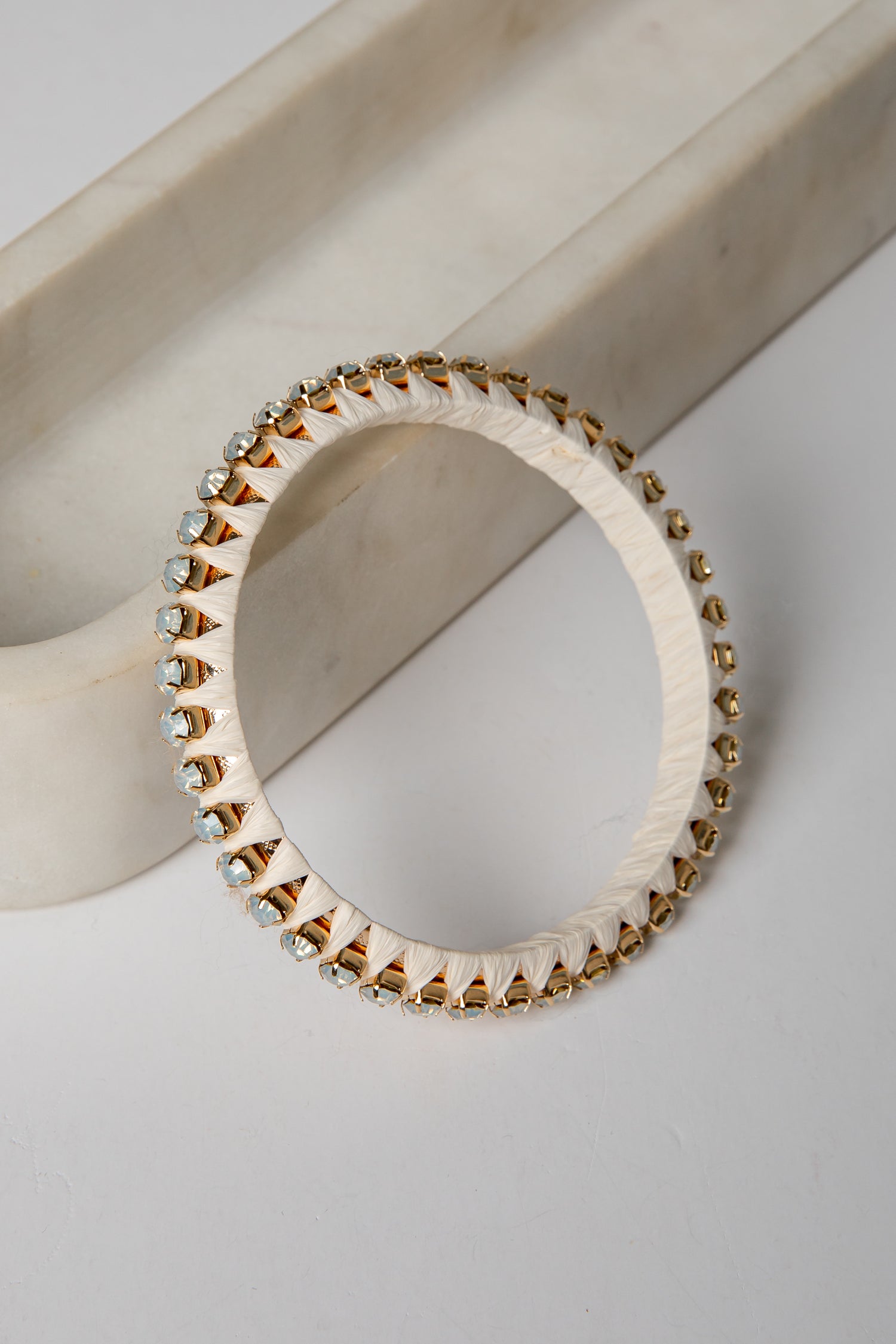 Bracelet with gold and silver beads on a light background