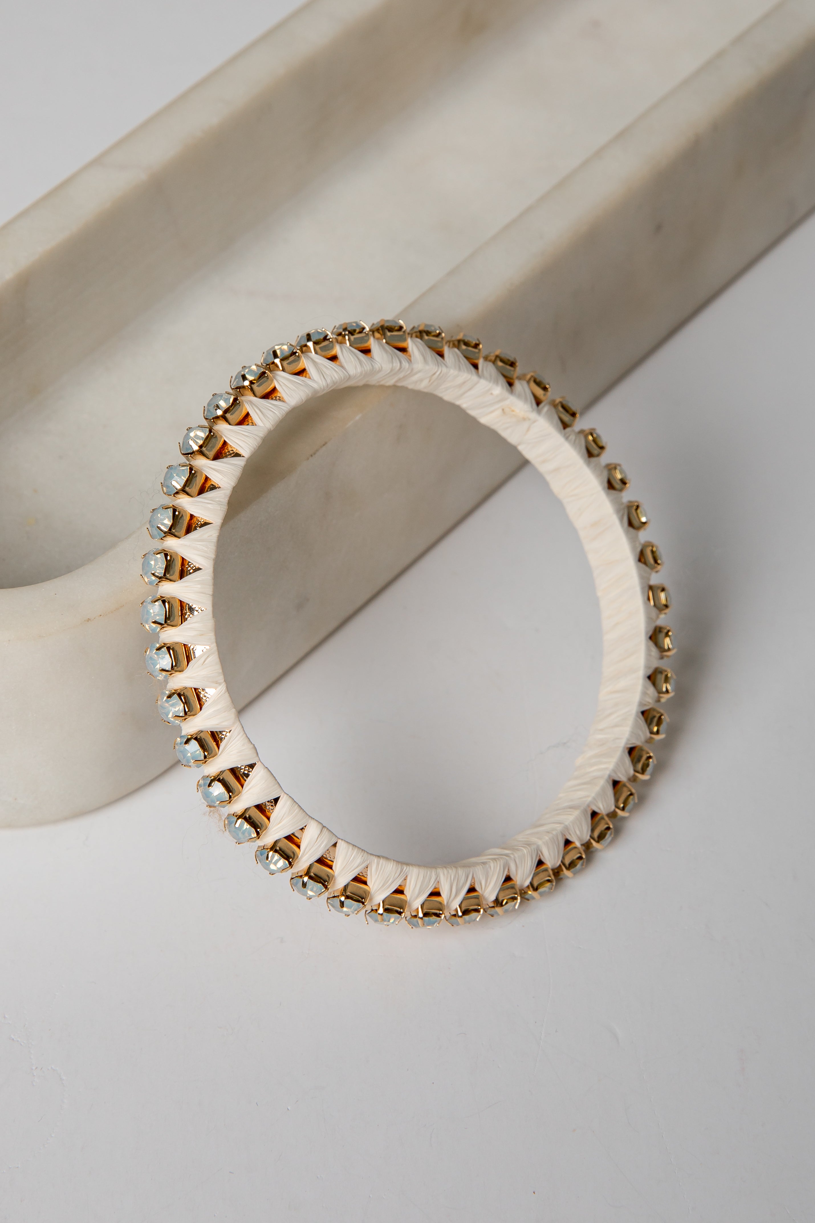 Bracelet with gold and silver beads on a light background