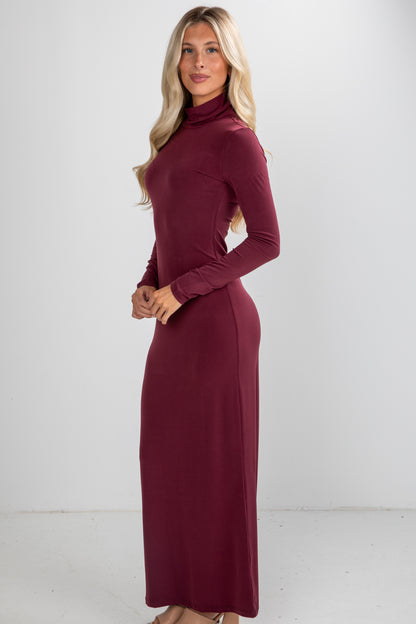 Woman wearing a burgundy long-sleeve dress against a white background