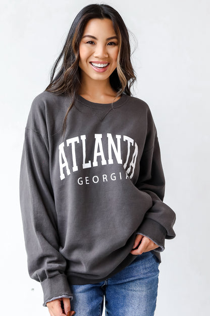 This comfy sweatshirt is designed with a soft and stretchy knit with a fleece interior. It features a crew neckline, long sleeves, a relaxed fit, and the words "Atlanta Georgia" on the front.