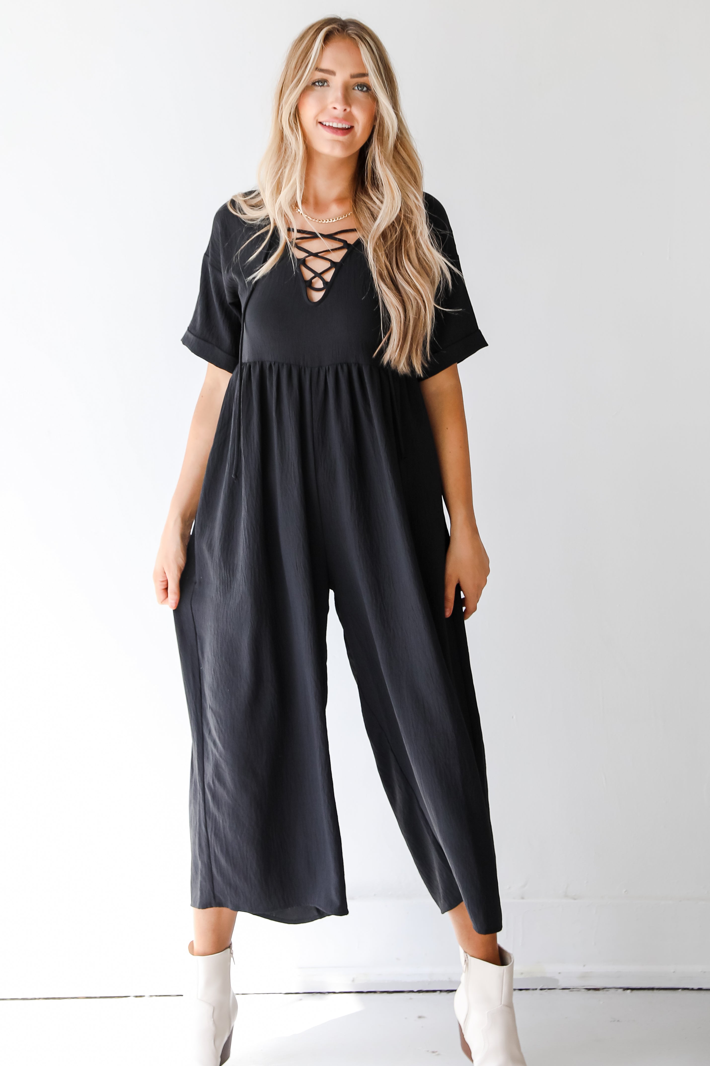 model wearing a black jumpsuit