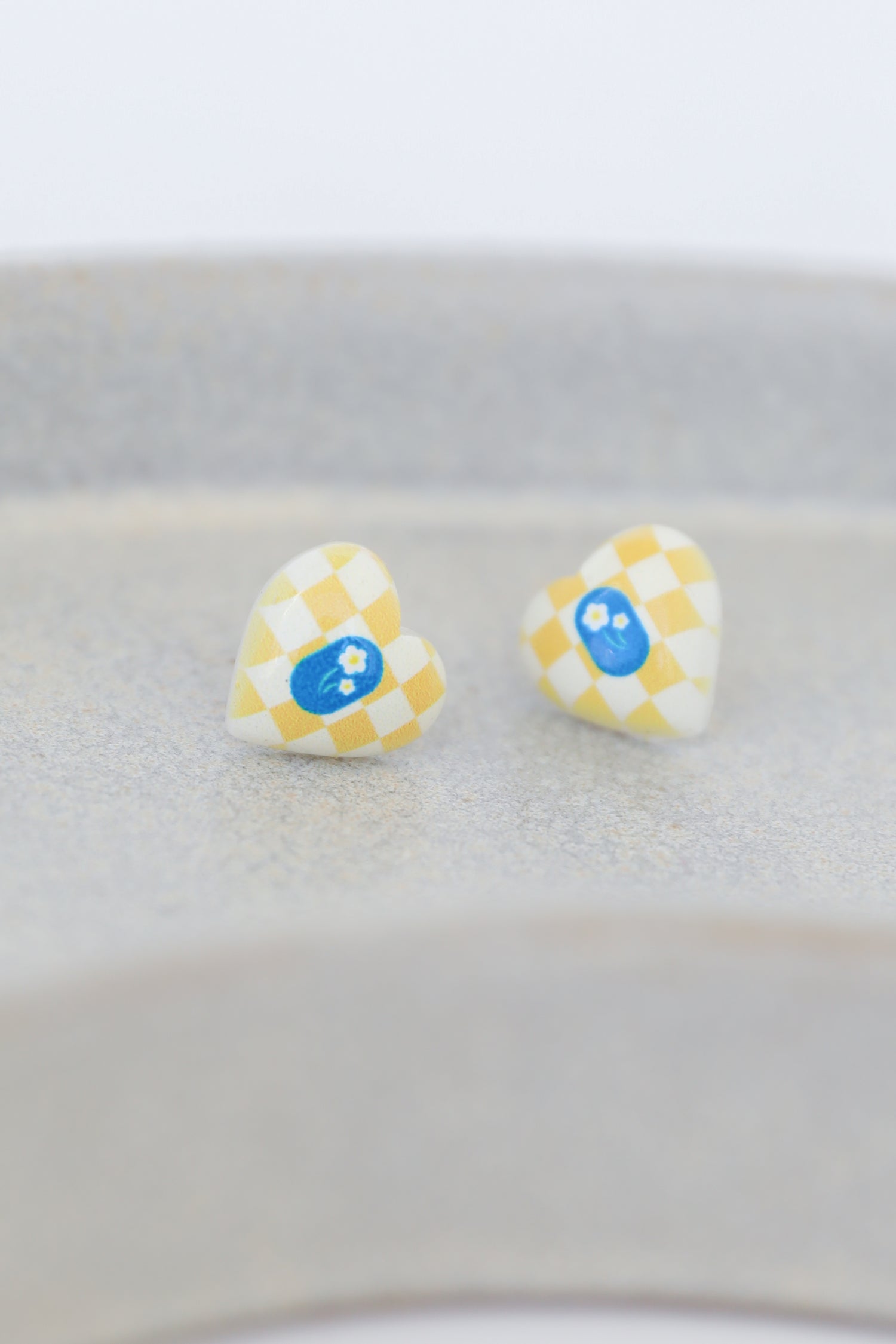 yellow heart earrings flat lay