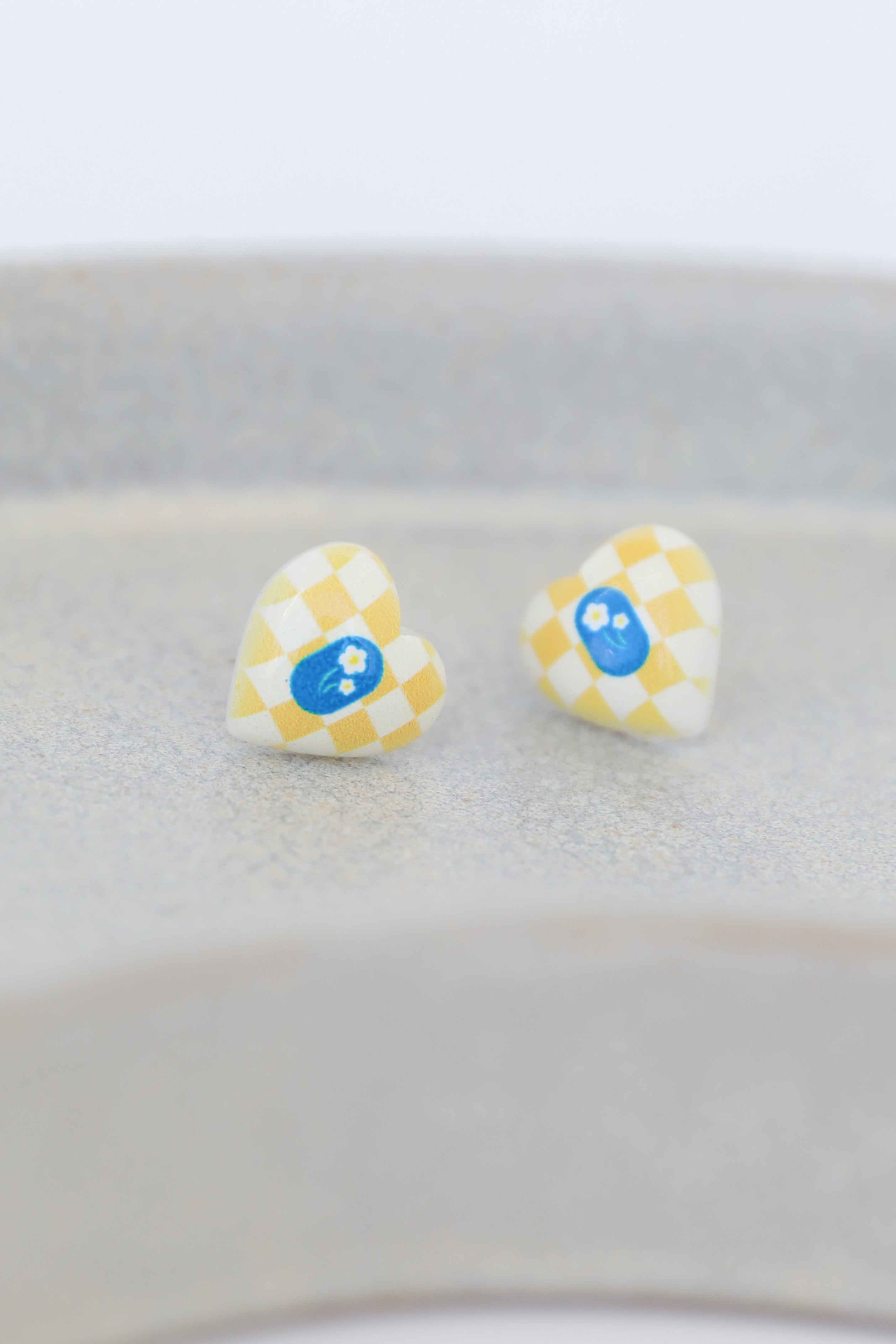 yellow heart earrings flat lay