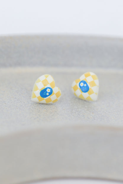 yellow heart earrings flat lay