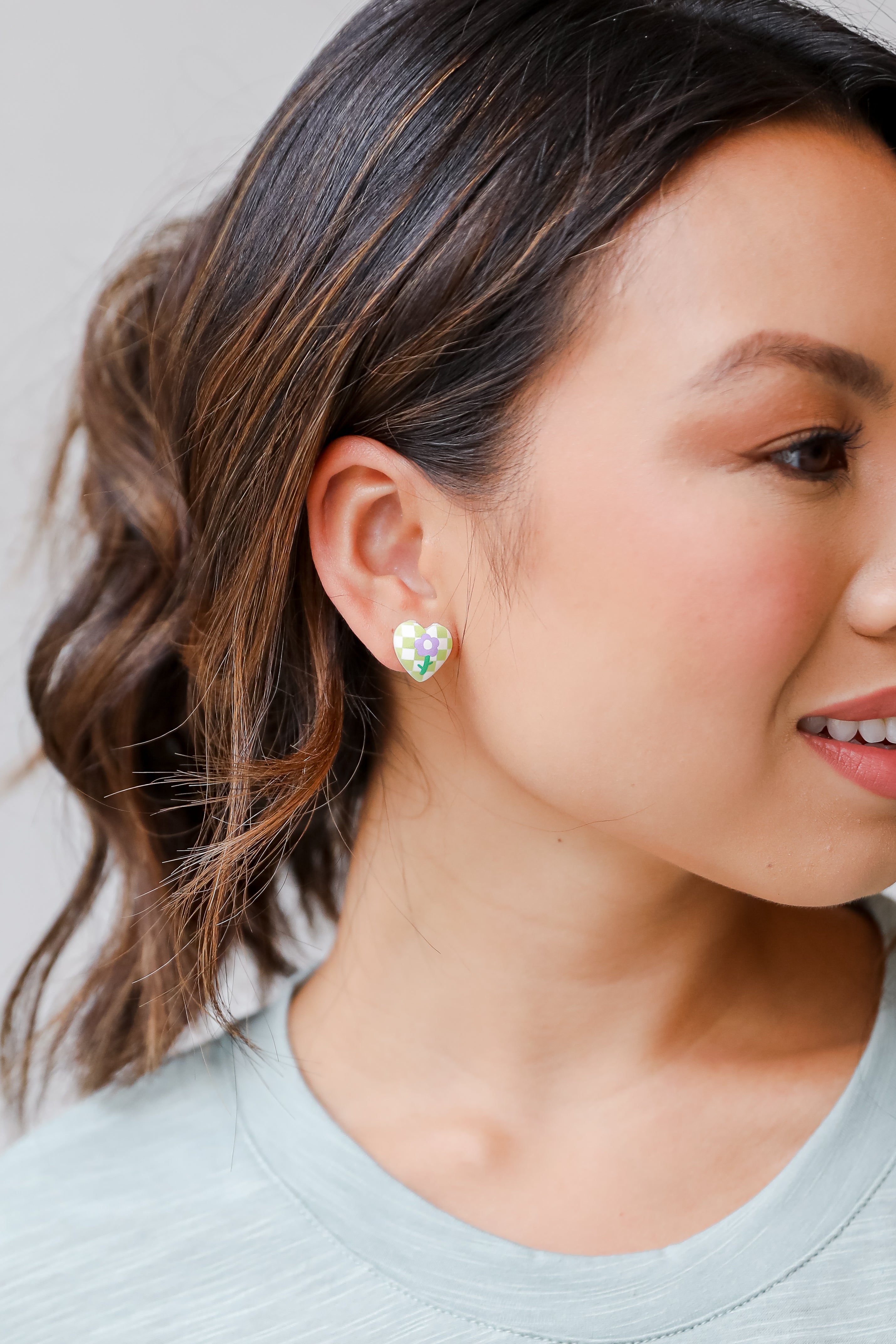 heart earrings in green on model