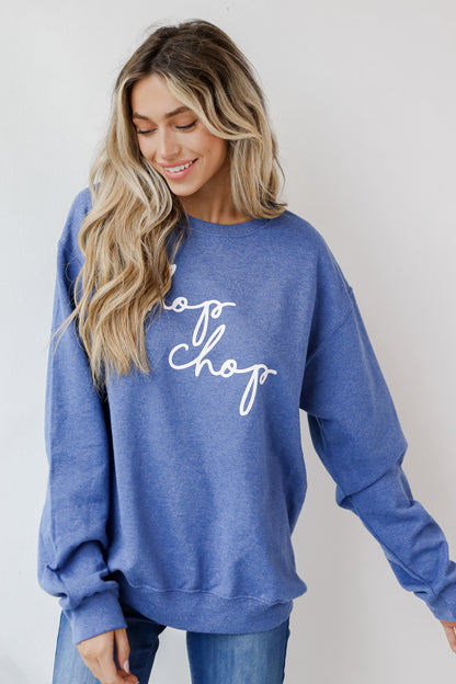 This comfy sweatshirt is designed with a soft and stretchy knit with a fleece interior. It features a crew neckline, long sleeves, a relaxed fit, and the words &quot;Chop Chop&quot; on the front. 