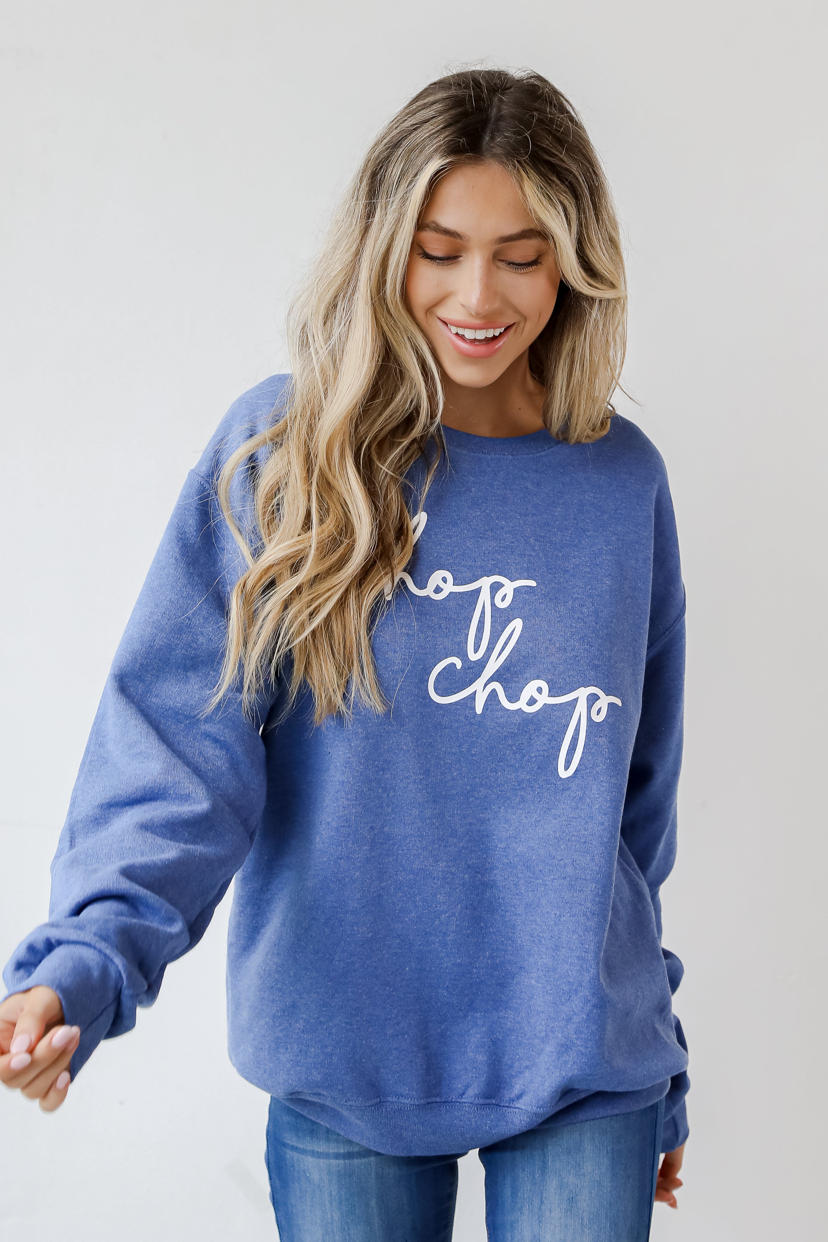 This comfy sweatshirt is designed with a soft and stretchy knit with a fleece interior. It features a crew neckline, long sleeves, a relaxed fit, and the words &quot;Chop Chop&quot; on the front. 